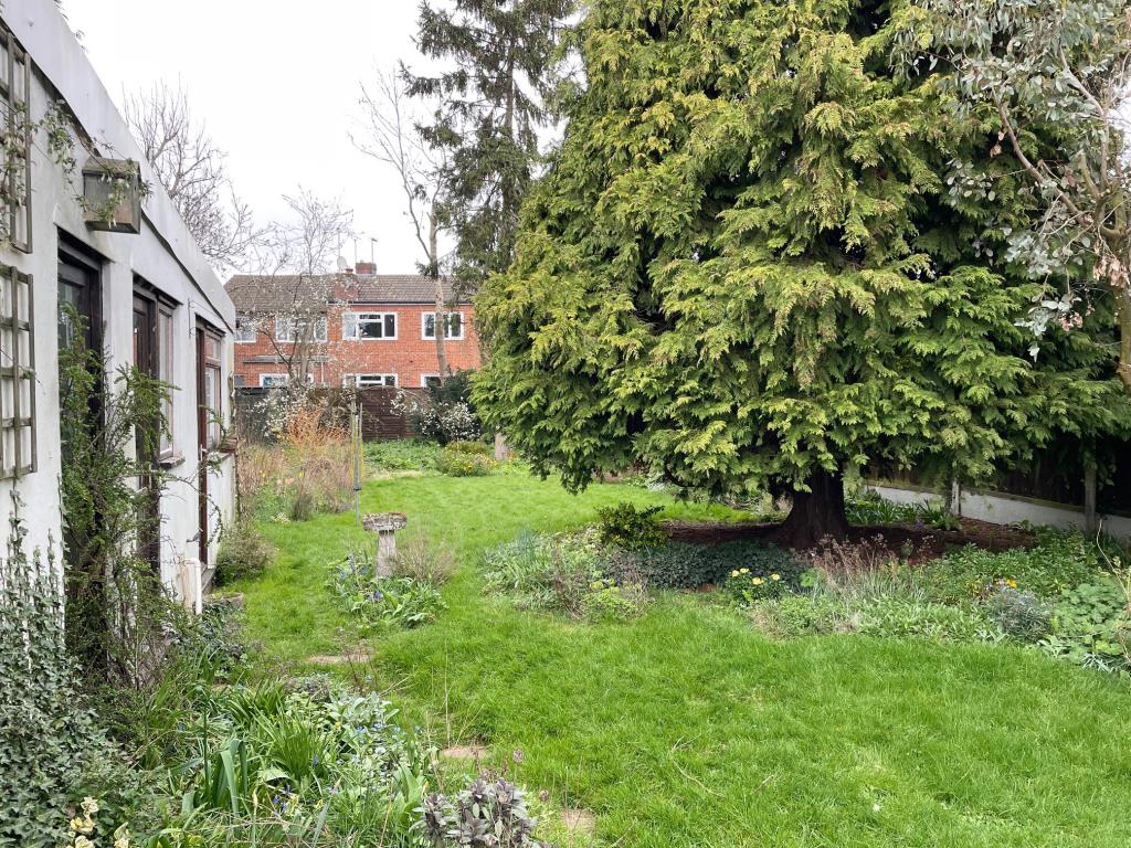 Lot: 63 - A DETACHED THREE-BEDROOM HOUSE SITUATED IN A POPULAR LOCATION FOR IMPROVEMENT - rear garden with workshop